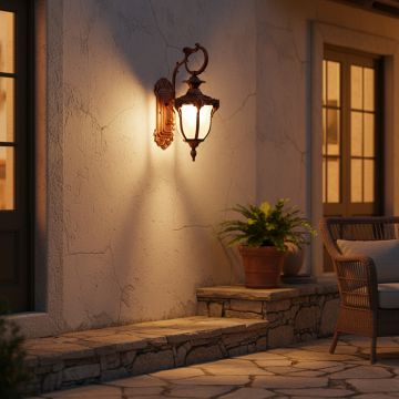 Classic outdoor wall light in bronze finish glowing warmly on villa exterior wall for stylish outdoor home lighting.