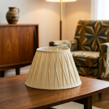 Cream pleated lampshade shown on bright white surface capturing its gentle tone and neatly crafted pleats for a stylish lighting accessory.