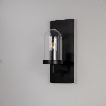Modern black metal wall sconce with clear glass dome shade light off white background for bedroom and hallway lighting.