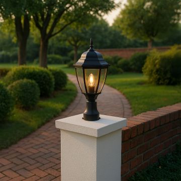 Elegant black outdoor pillar lamp glowing warmly on garden pathway pillar creating stylish ambience for entrance lighting.