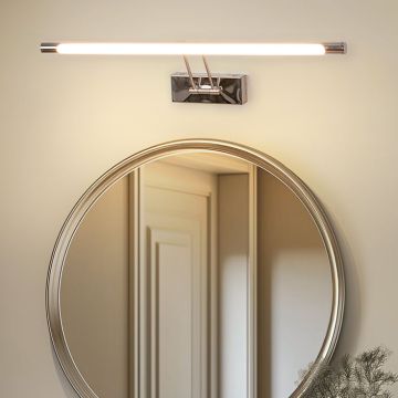 Lifestyle closeup of chrome picture light illuminating artwork with warm LED glow for elegant picture frame wall lighting.