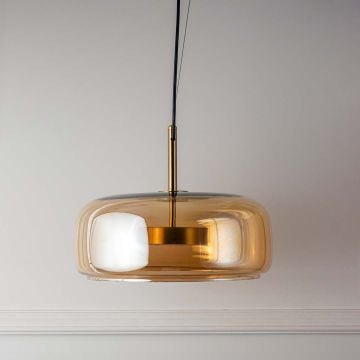 Golden glass pendant light with rounded shade and metal fixture turned off on plain white background.
