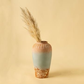 Tall terracotta and sage ceramic vase styled in a warm modern living room adding earthy artistic charm to consoles shelves and hallway interiors.