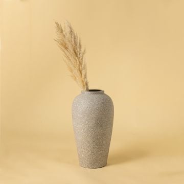 Light grey textured terracotta vase styled in a warm interior adding soft handcrafted elegance and natural simplicity to modern home decor styling.