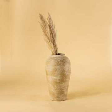 Rustic beige terracotta vase styled in a warm interior adding earthy handcrafted charm and natural textured elegance to modern home decor styling.