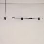 Linear pendant light turned on against white background showing evenly spaced light heads with sleek modern metal finish.
