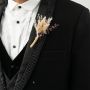 Stylish wheat boutonniere on black background rustic groom lapel pin wedding accessory.