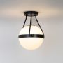 Black ceiling light with glowing frosted glass globe displayed on clean white background for modern ceiling lighting.