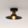 Industrial ceiling light with black dome shade and gold holder glowing warmly with exposed bulb on white background.