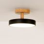 Black metal and wood ceiling light illuminated on a clean white background showing soft ambient glow.