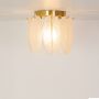 Gold metal ceiling light with frosted glass leaf panels shown with lights on against a white background highlighting its warm ambient illumination.