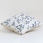 White cotton cushion cover with navy blue botanical pattern designed to bring a calm natural touch to home décor while offering a soft breathable and skin friendly fabric feel.