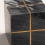 Closeup of the black marble cube showcasing the detailed gold accent lines and smooth marble texture.
