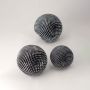Grouped black and white textured spheres arranged together for a chic and contemporary home decor setting.