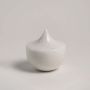 White ceramic decor item featuring a sharp peak design placed on a plain white background ideal for modern interior design.