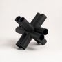 Minimalist black geometric decor sculpture displayed on neutral white background for modern home styling.