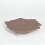 Large brown ceramic serving platter with textured pattern and wavy edges isolated on clean white background.