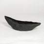 Black ceramic decorative platter with angular faceted texture isolated on clean white background for modern table decor styling.