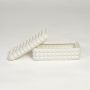 White ceramic textured storage box with matching lid isolated on white background for elegant home organization decor.