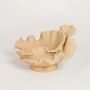Beige ceramic ruffled decorative bowl with layered organic design isolated on white background for modern home decor display.