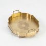 Octagonal antique gold brass tray with floral engraved center and upright handles displayed on white background.