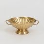 Decorative gold metal fruit bowl with twin ornate handles and fluted texture displayed on plain white background.