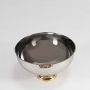 Polished silver fruit bowl with gold base displayed on white background showing clean shape and high shine.
