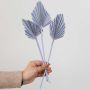 Light purple dried palm leaf displayed on white background for stylish vase decor and modern interior styling.