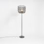 Stylish black wire frame floor lamp with glowing bulb design for modern home lighting décor.
