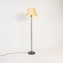 caelis linear black floor lamp with suede shade gold light on white background