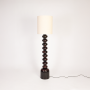 Floor lamp on white background with light off revealing full height stacked design neutral shade and minimal form for modern living rooms.