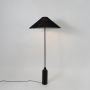 Modern floor lamp with matte black conical shade and cylindrical base ideal for ambient lighting in stylish interiors.