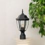 Classic black outdoor pillar light with clear glass shade placed on stone pillar ideal for garden and patio decoration.