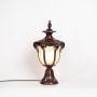 Vintage style outdoor pillar light with glowing frosted glass and brown finish ideal for terrace driveway and patio use.