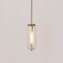 Pendant light with gold finish holder and clear cylindrical glass shade glowing warmly on plain white background