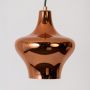 Closeup view of copper metal pendant light showing high gloss surface curved silhouette and detailed craftsmanship.