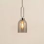 Smoked glass pendant lamp with silver-toned metal top softly glowing against a white background perfect for kitchens dining areas and hallways.