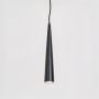 Black cone pendant light in matte metal finish glowing on white background for stylish and contemporary home interiors.