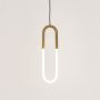 Contemporary gold pendant light with U shaped LED tube glowing softly displayed on plain white background for product showcase.