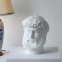 White sculpted head décor piece in a front view ideal for artistic décor styling and modern pedestal display.