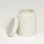 White ceramic decorative jar with geometric pattern and lid isolated on clean white background for stylish tabletop decor use.