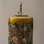 Closeup of Botanical Bloom tall ceramic jar showing detailed botanical painting and gold accent finish on the lid.
