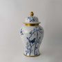 Elegant ceramic jar with blue floral butterfly artwork and golden lid crafted for luxury home and table decor.
