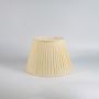 Cream fabric lamp shade displayed on white background highlighting pleated texture for table lamp or floor lamp decor styling.