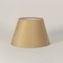 Simple beige lampshade shown on a bright white backdrop with a soft textured surface and classic tapered shape ideal for modern table and floor lamp styling.