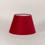Classic red lampshade shown on a bright white surface capturing its elegant tapered form and soft fabric finish for stylish lighting setups.
