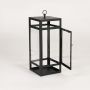 Black metal candle lantern with clear glass panels on white background designed for tabletop floor and patio Decor lighting.