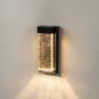 Contemporary wall light with black rectangular frame and textured glass diffuser on a white background.