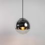 A smoked glass globe pendant light shown with light on against a white background highlighting its warm glow and modern rounded reflective shape.