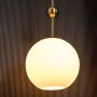 Frosted Glass Globe Gold Metal Pendant Light On Black Background